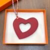 UK London 187 Factory Orange Togo Leather / Rouge Casaque Epsom Hollow Heart Charm